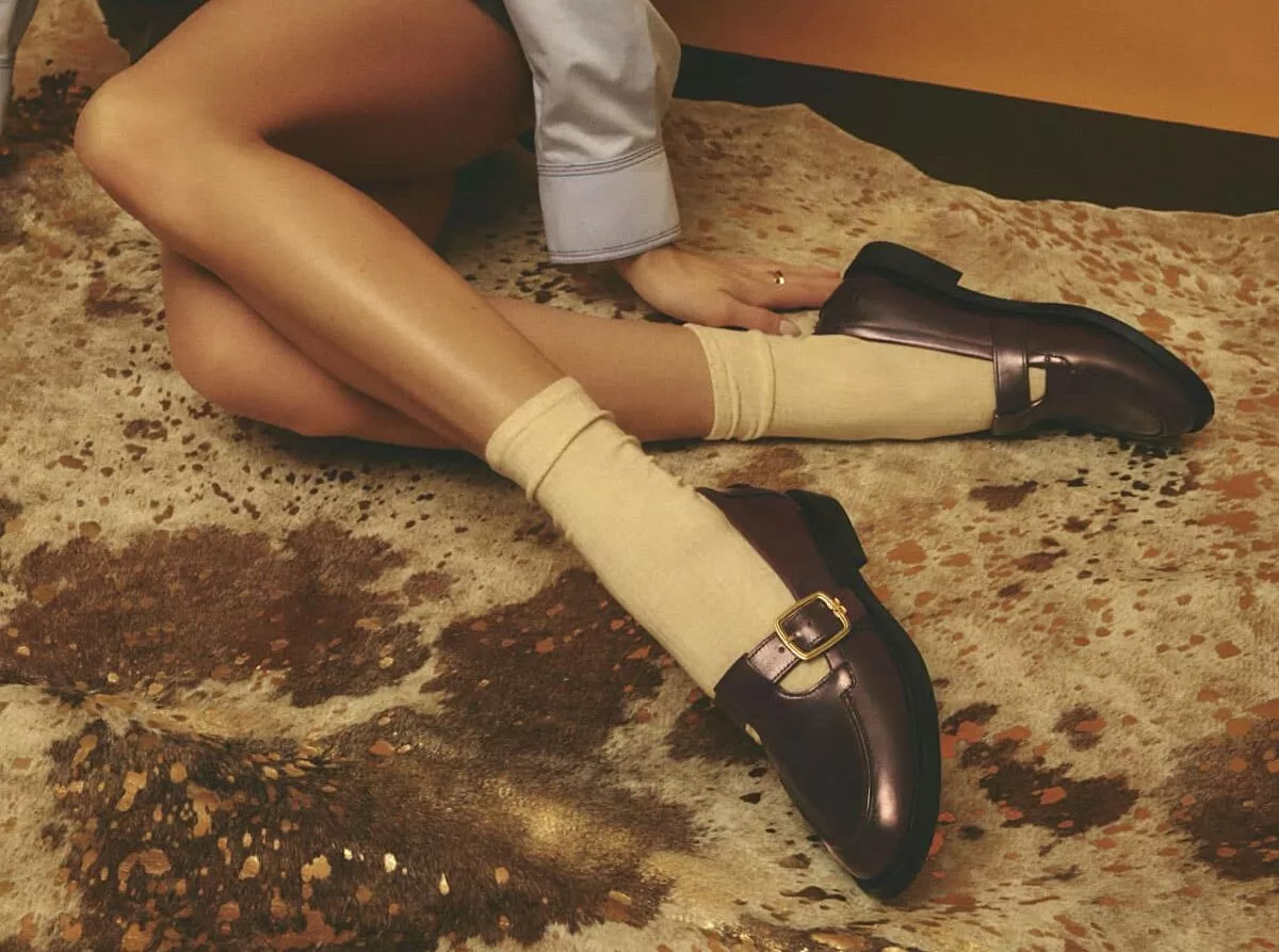Person sat down, showing buckled shoes