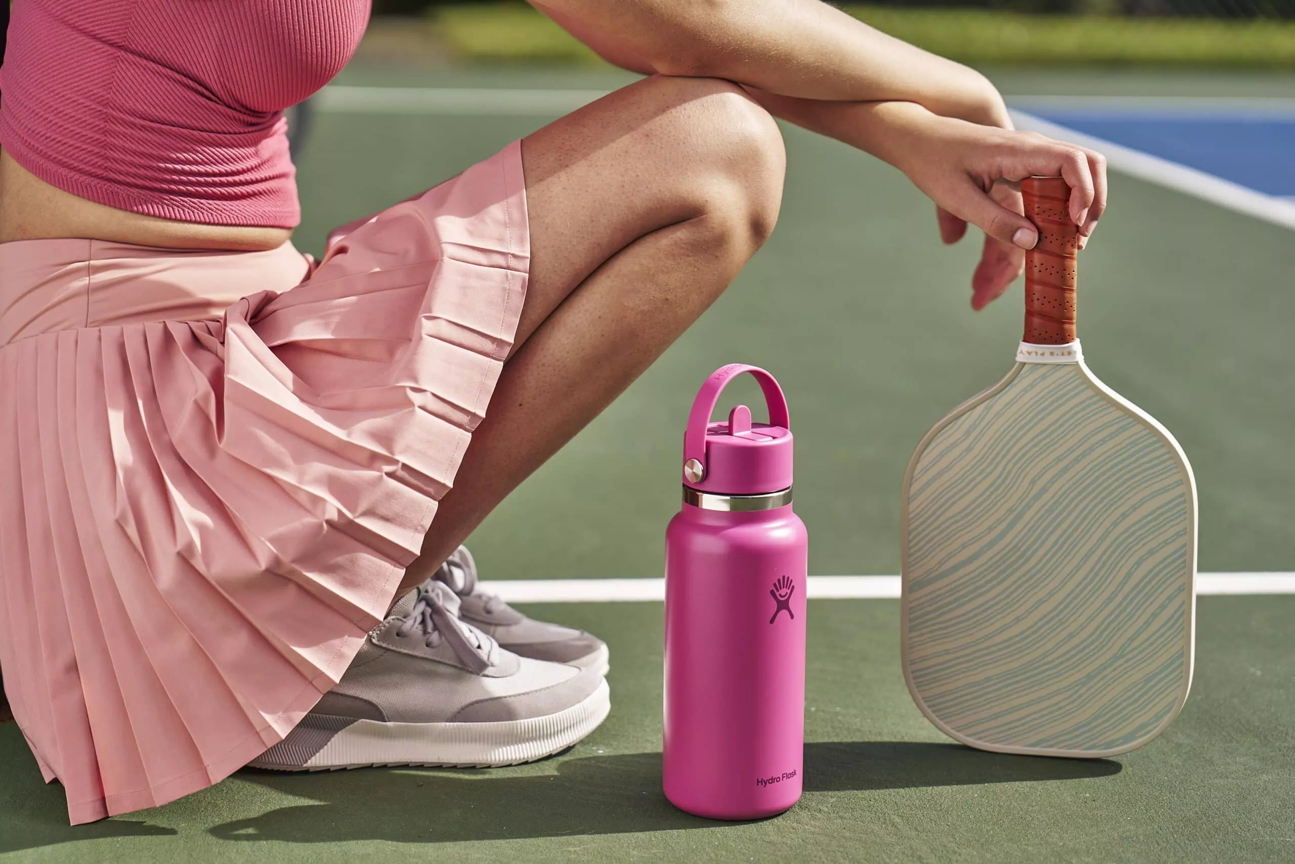 Woman in paddle gear with pink hydroflask bottle